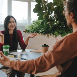 Happy businesswoman having discussion with businessman at desk in office model released, Symbolfoto property released, YTF03299